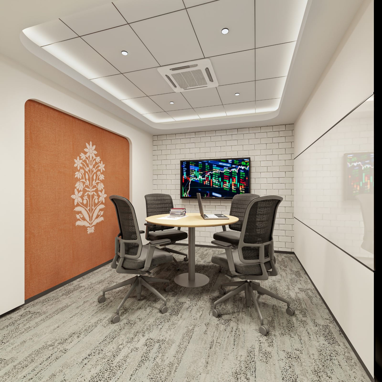 A modern corporate meeting room featuring a round light wood-tone table with four ergonomic grey mesh chairs, centered on patterned carpet tiles. An accent wall in terracotta with a traditional floral motif provides a striking contrast to the white brick-patterned wall opposite, which displays a large screen showing financial data under a multi-layered ceiling with perimeter cove lighting.